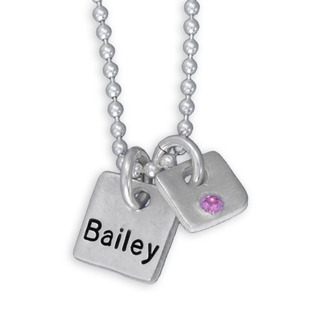 Fine silver Mini Squares personalized necklace, hand stamped with kid's name and with an embedded birthstone, shown close up on white