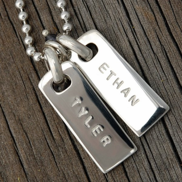 Custom silver rectangle pendants, personalized with kids' names Ethan and Tyler hand stamped on the charms, with the letters left unblackened