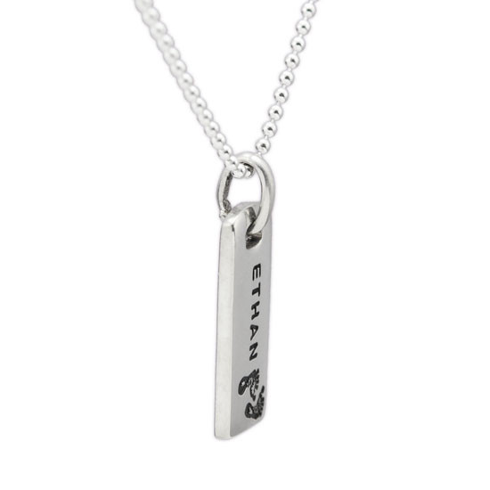 Side view of custom hand stamped Rectangle Warmth Necklace, with the silver rectangle charm personalized with son's name "Ethan", and stamped with footprints