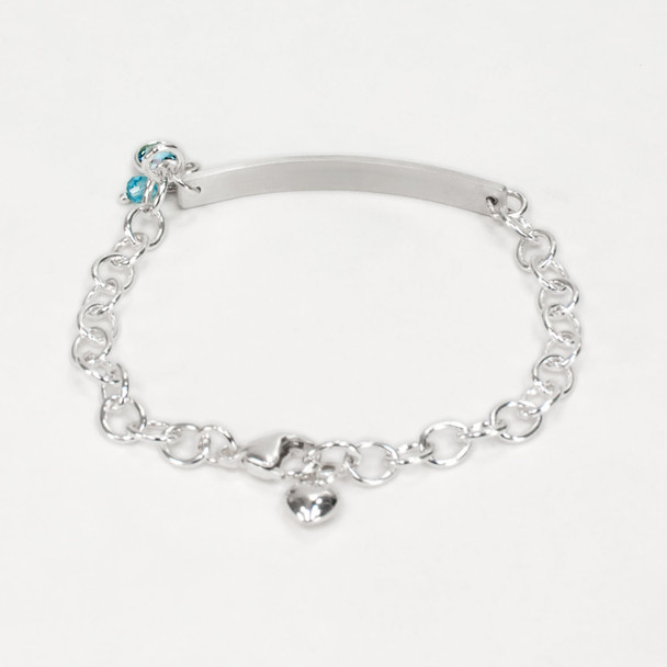 Hand stamped ID Bracelet made from sterling silver, shown from the back, with birthstone on white