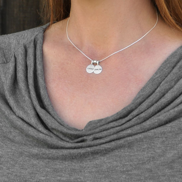 Personalized Sterling Circles of Affection, custom hand stamped silver charms with kids names, with a silver spacer bead, shown with a snake chain on a model