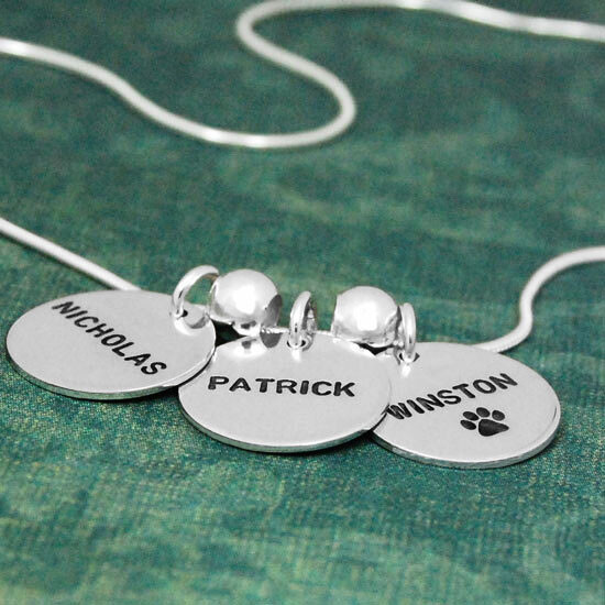 Our 3/4" sterling Silver Name Discs, with grandkids' names hand stamped in Block Upper font, shown from the side