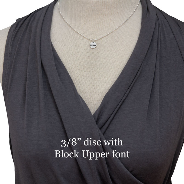 Sterling Name Disc necklace with child's name "Penny", stamped on 3/8" silver charms in Block Upper Case font, shown on model