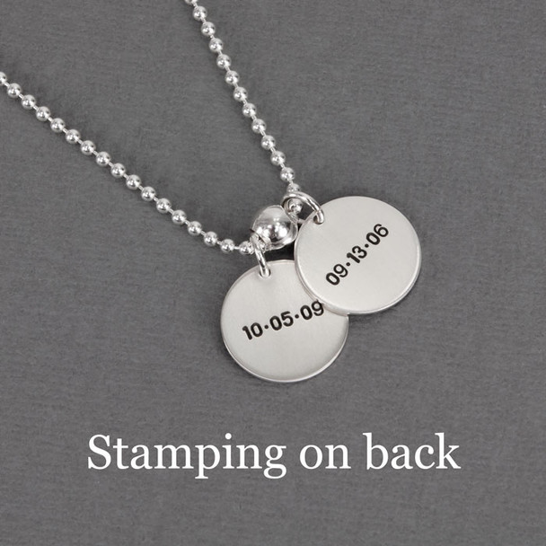 Kids' birthdays custom stamped on back of silver mother's necklace with 5/8" discs, in block upper font