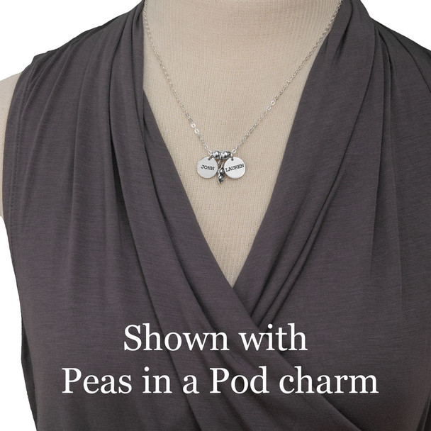 Sterling Name Discs with kids names hand stamped in Typewriter Upper Case font, on 1/2" silver circle charms, with silver Peas in a Pod charm, shown on model