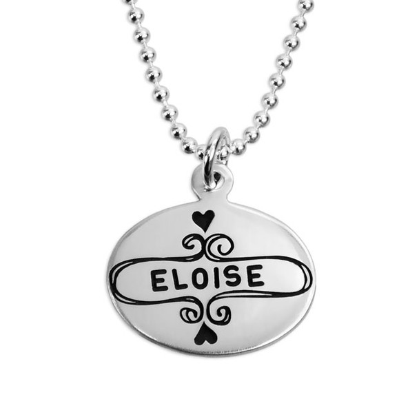 Sterling silver oval charm engraved with a sweet frame and personalized with a name or word stamped in the middle.  Hung on a silver chain, and shown close up on white
