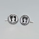 Sterling silver personalized cuff links with your kid's hand prints or footprints, shown on a gray background, with Alexis and Abby names hand stamped on them