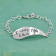 Side view of Memorial silver handwriting angel wing bracelet