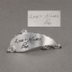 Custom Memorial Silver Handwriting Angel Wing Bracelet, personalized with loved one's signature and handwritten note, shown with original handwriting