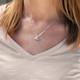 Custom silver heart initial necklace on model