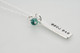 Kissme lowercase stamping on custom sculpted silver long rectangle, personalized with the name Ava Rose and green birthstone