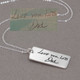 Sculpted Handwriting Memorial Silver Necklace, shown with original handwritten note used to create it