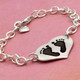 Side view of custom silver heart bracelet personalized with your child's actual footprints or handprints