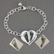 Custom silver heart bracelet personalized with your child's actual footprints, shown with original footprints