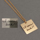 Custom Gold charm necklace with handwriting, shown with original handwritten note used to create it