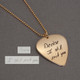 Anniversary present of gold guitar pick with spouse's actual handwriting, shown on with original handwriting used to personalize the pick