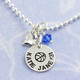 Custom silver circle charm necklace for an athlete, personalized with basketball symbol, the player's name and number, along with a team color blue birthstone and silver puffed heart charm. 