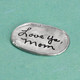 Handwritten signature from Mom on personalized memorial fine pewter oval pocket charm, shown from the side
