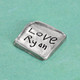 Square Handwriting Pocket Token made from fine pewter. Token is hand-cast and designed to  an organic square with raised edges and your handwriting inscribed, shown close up from the side