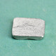 Square Handwriting Pocket Token made from fine pewter, shown from the back at an angle 