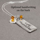 Back side of rectangle family necklace in silver with handwriting, shown with original handwriting etched on the back