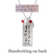 Back side of rectangle family necklace in silver with handwriting, shown with original handwriting used to personalized it