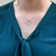 Sterling silver small heart for custom handwriting on necklace with birthstone, shown close up on white. shown on a model