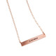 Wide view of custom rose gold bar necklace, personalized with hand stamped roman numerals, shown on white