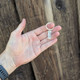 Silver handwriting key ring shown in a model's hand