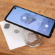 Using a water glass as a tripod for your mobile phone to take a clear, well-lit photo of your fingerprint.