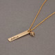 Side view of  custom Gold Handwriting Tag Necklace, personalized with name "Selma", with gold heart