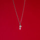 Wide view of handmade silver necklace with CZ stone with moonstones, shown on red