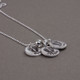 Custom Footprints/Handprints Silver Necklace,  shown from the side