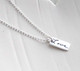 Dainty Custom Silver Handwriting Tag necklace, personalized with loved one's handwritten word "Love", shown from the side