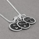 Silver Etched Name Disc Necklace personalized with kids names, shown from the side