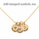 Hand stamped custom Gold Name Discs necklace personalized with kids names and symbols, shown close up on white
