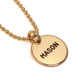 Hand stamped custom Gold Name Discs necklace personalized with son's name, shown from the side on white