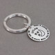 Custom hand stamped silver key chain for kid, personalized with parents' note, shown from the side
