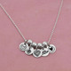 Personalized Lil Love silver discs, custom stamped with an image, shown on a chain to make a necklace
