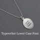 Custom sterling silver oval charm necklace, personalized with stamped inspirational phrase using Typewriter Lower Case font