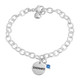 Hand stamped sterling silver custom mom bracelet, stamped with child's name, and blue birthstone, shown on white