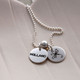 Two 1/2" silver discs, one with a child's name stamped in Block Upper font, and one with a dragonfly