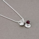 Silver Tiny Round Initial Charm necklace, shown close up from the side