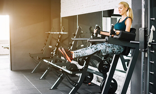 A gym with a row of squat racks that say power racks - image