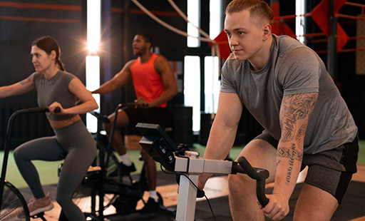 A row of scifit exercise bikes in a gym - image