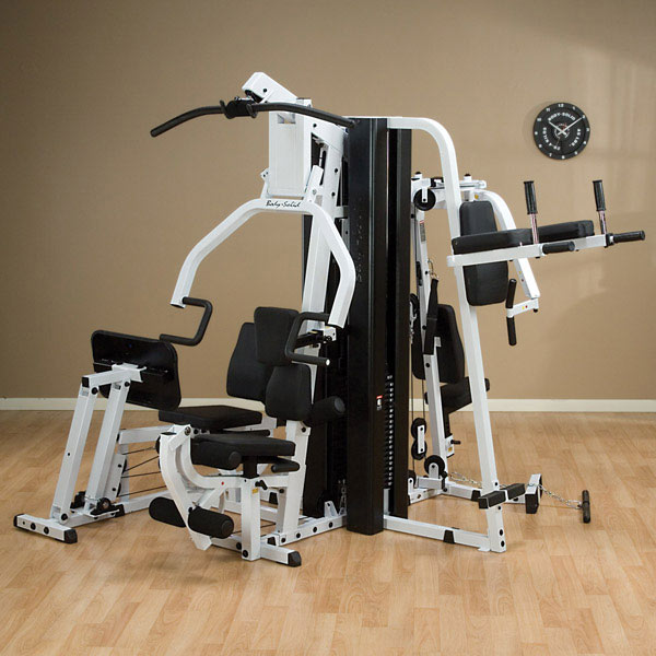 A body solid exercise machine is sitting on a wooden floor - image