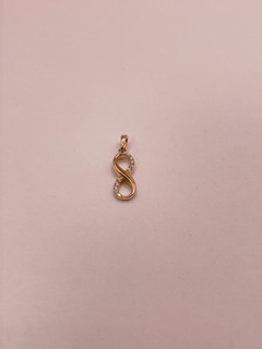 La Petite Bourgeoisie fine jewelry. 10 karat gold eternity symbol pendant.