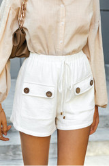 Women's white linen shorts with elasticized waistband and front pockets