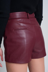 maroon red faux leather high-waisted shorts with belt