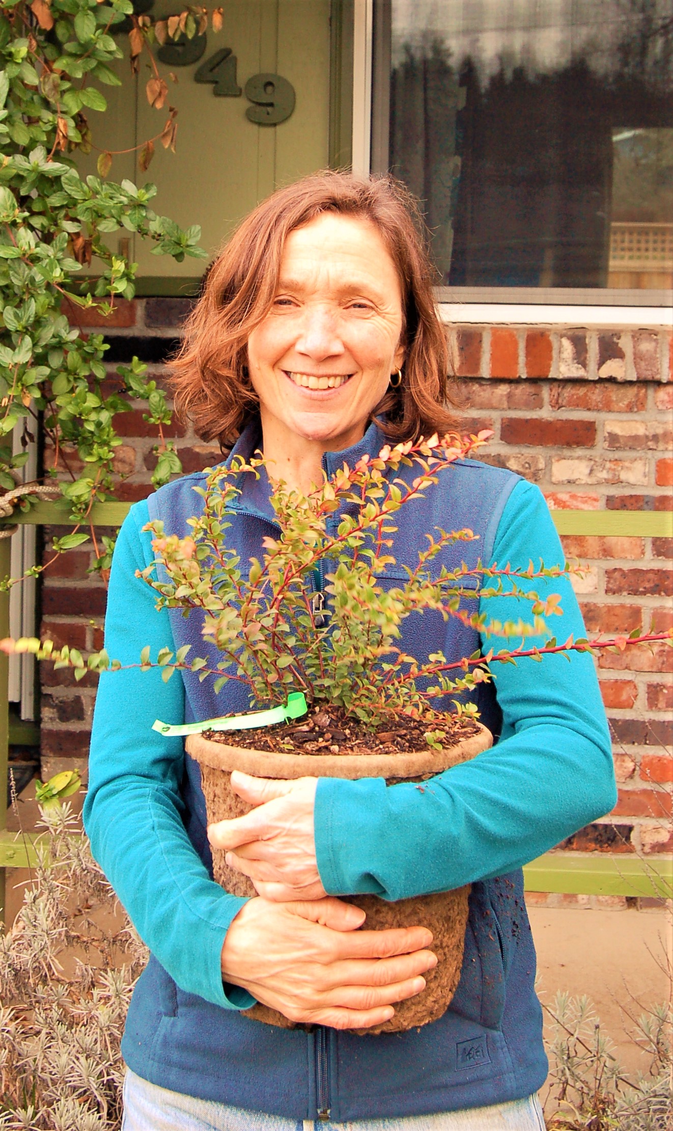 darcy holding potted plant